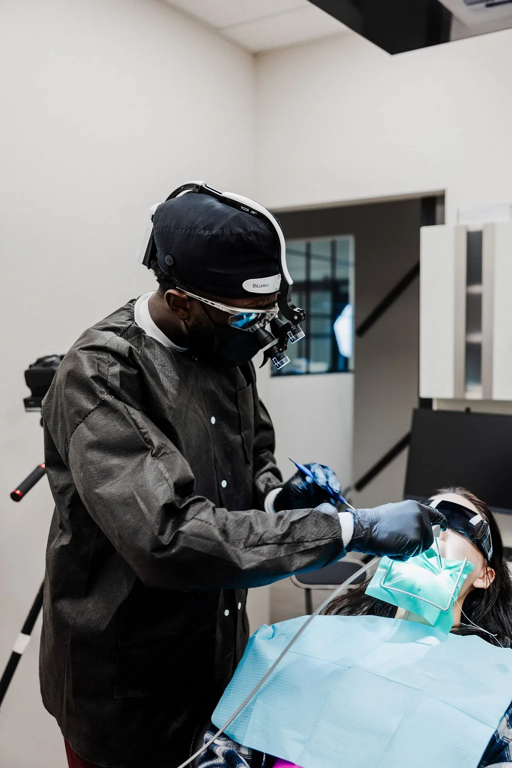 Dr. Ennuson in loupes treating a patient chairside