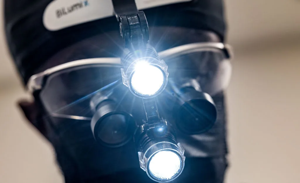 Close-up of dental magnification loupes with the headlight on