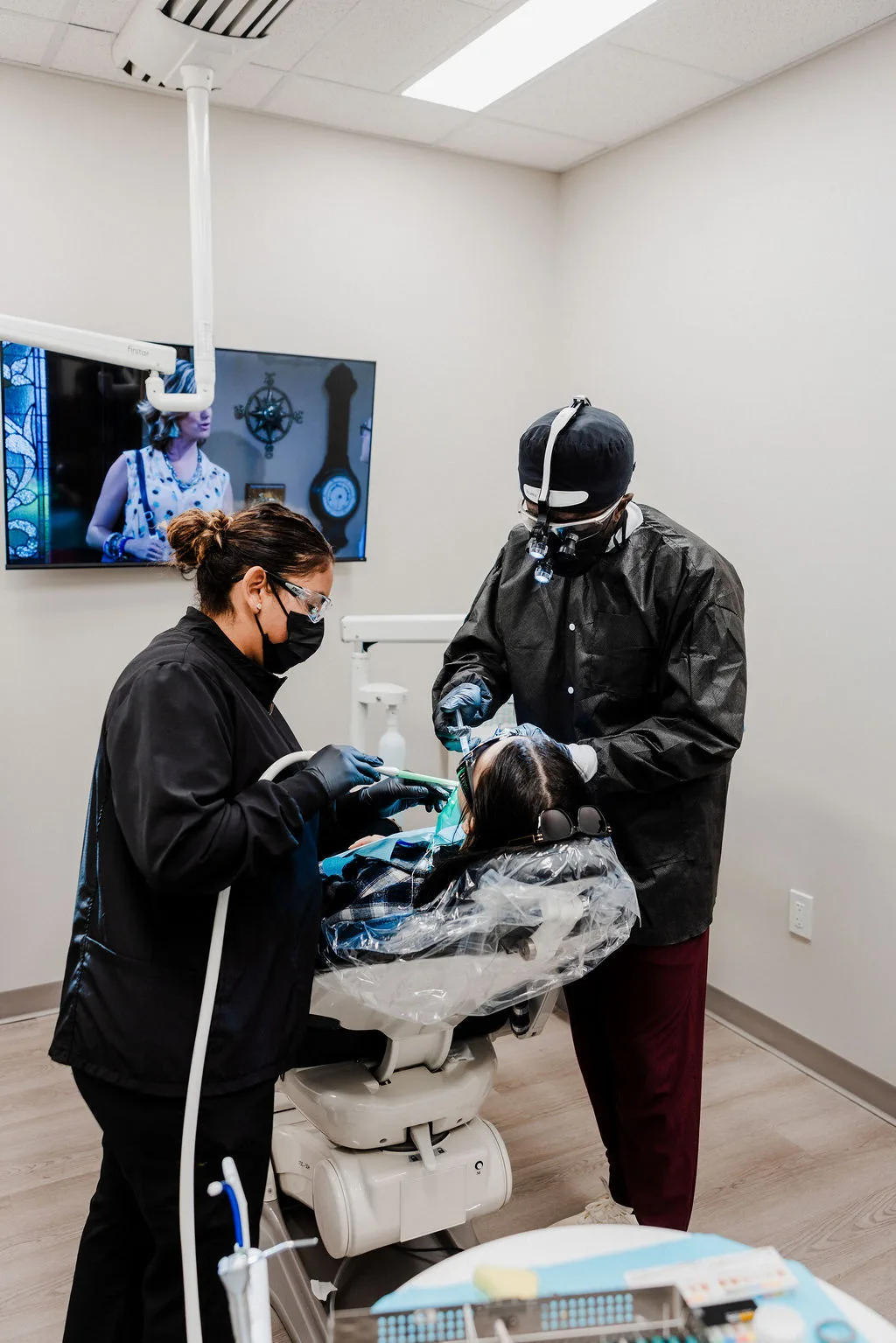 Dr. Ennuson and an assistant treating a patient in the treatment room